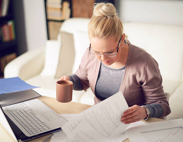 istock blonde woman working at home 468631968