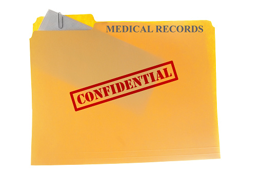 Medical records envelope attached to a  file-folder with Confidential text, isolated on white