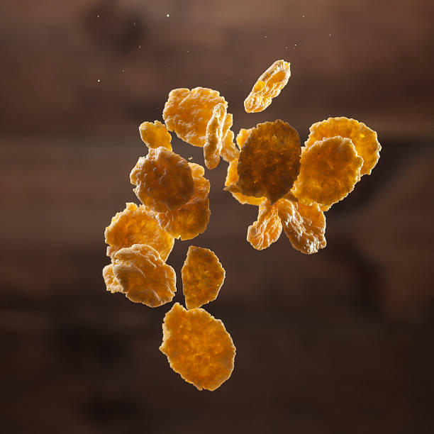 istock Falling corn flakes on wooden background 468635060