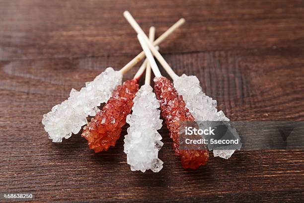 Crystal Brown And White Sugar Candy On Brown Wooden Background Stock Photo - Download Image Now