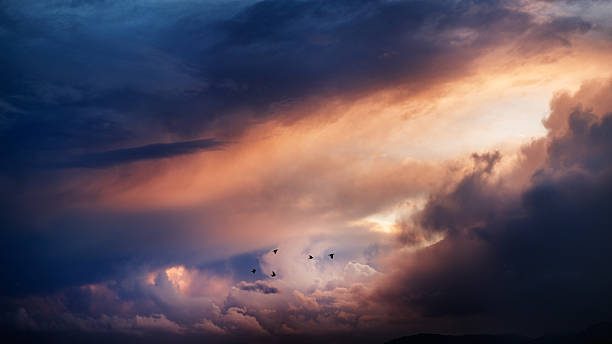 istock Suggestive sunset sky with clouds split by ray of light 468638506