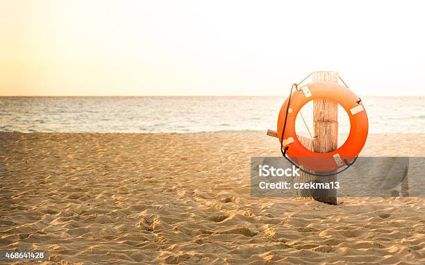 Life Preserver On Sandy Beach Stock Photo - Download Image Now - Life Belt, 2015, Assistance