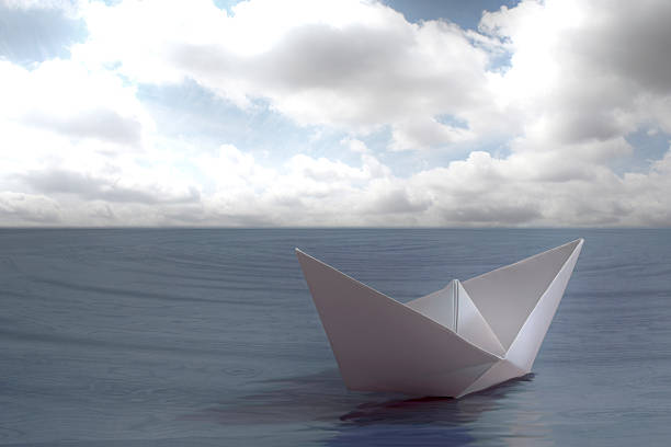 istock Paper boat floating in the sea 468642935