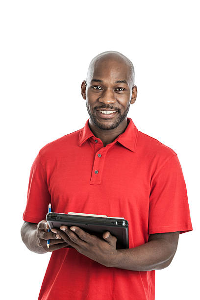 A man in a red polo writing on a clipboard