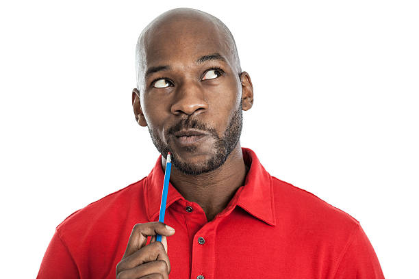 Handsome black man thinking Handsome late 20s black man with pencil on chin thinking isolated on a white background man thinking stock pictures, royalty-free photos & images