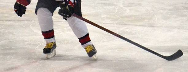 istock Young Ice Hockey Player Challenging for the Puck 468647456