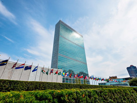 New York City, USA - August 21, 2014: UN Headquarters in a summer day. Many flags are blowing this means that the assembly is meeting