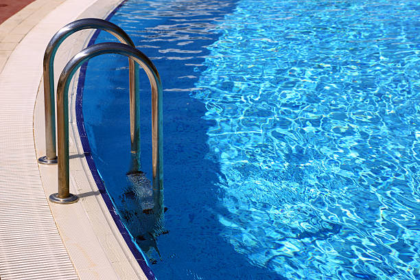 istock swimming pool with metal railings 468652210