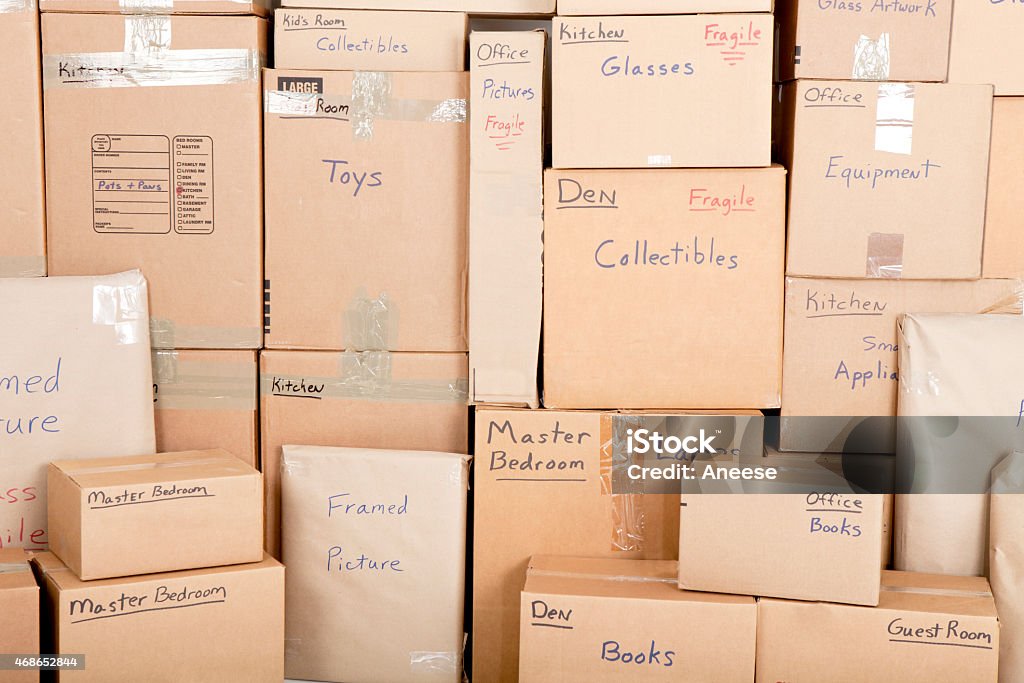 Moving boxes Wall with boses labled and ready fpr shiping Box - Container Stock Photo