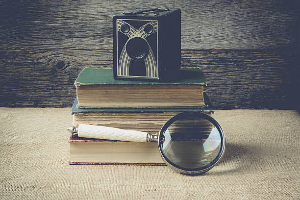 istock books, camera, and magnifying glass on retro background 468653714