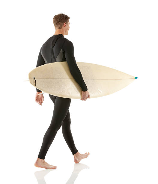 istock Rear view of surfer holding surfboard 468657856