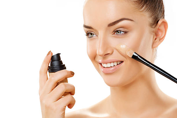 istock woman applying foundation 468658309
