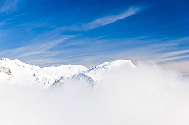 Fog at top of the mountain on winter sunny morning Clash between fog and the sun at the top of the mountain on a winter morning, slovenian Alps krvavec stock pictures, royalty-free photos & images