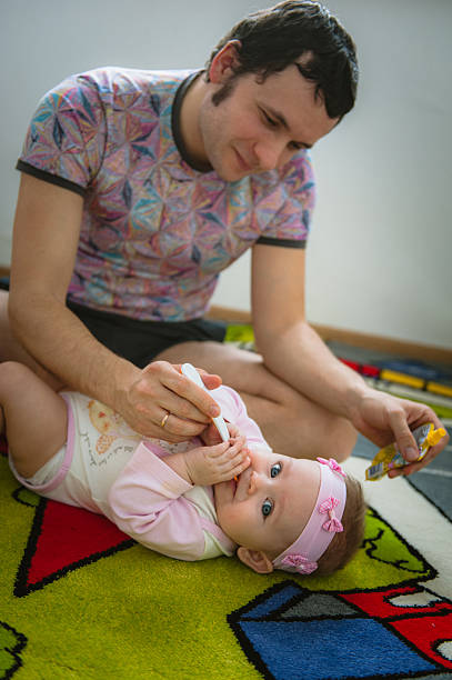 istock Papa feeds child with spoon 468661856