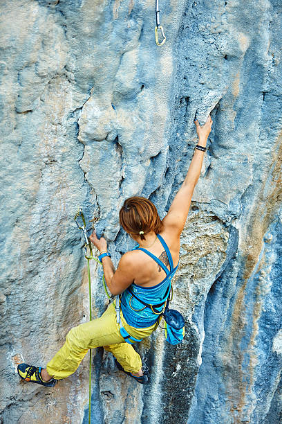 istock Rock climber climbing up a cliff 468662392