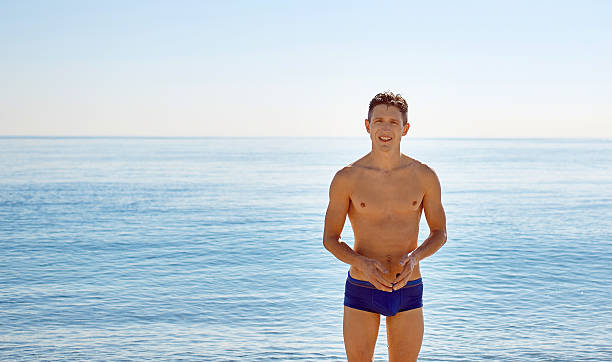 istock young man on the sea background 468663380