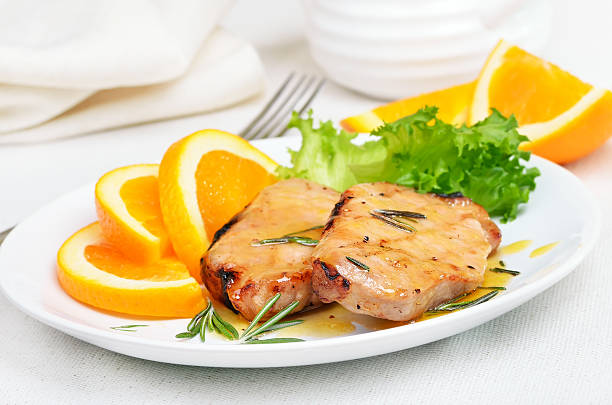 istock Pork chop with orange sauce 468663392