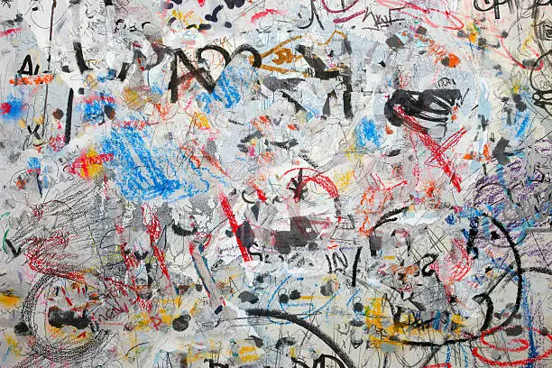 Photo of Grunge graffiti wall background: spray paint, strokes, coloured street art