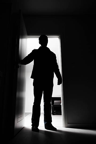 istock Full-length of thief breaking into house 468664335