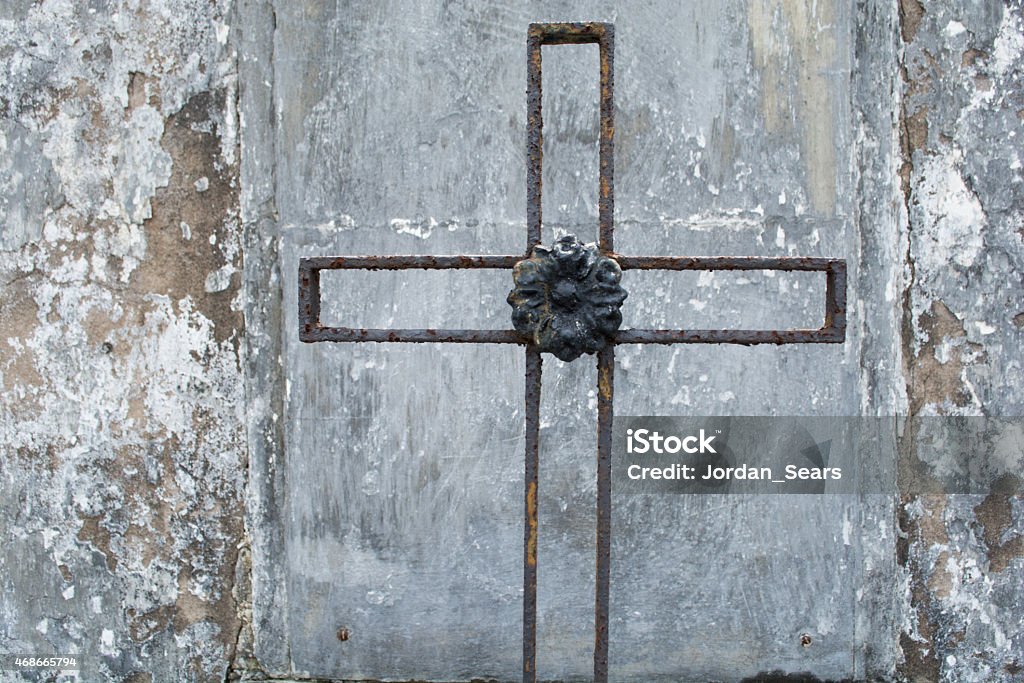 Rusted Iron Cross A rusted iron cross on a gravesite in New Orleans 2015 Stock Photo