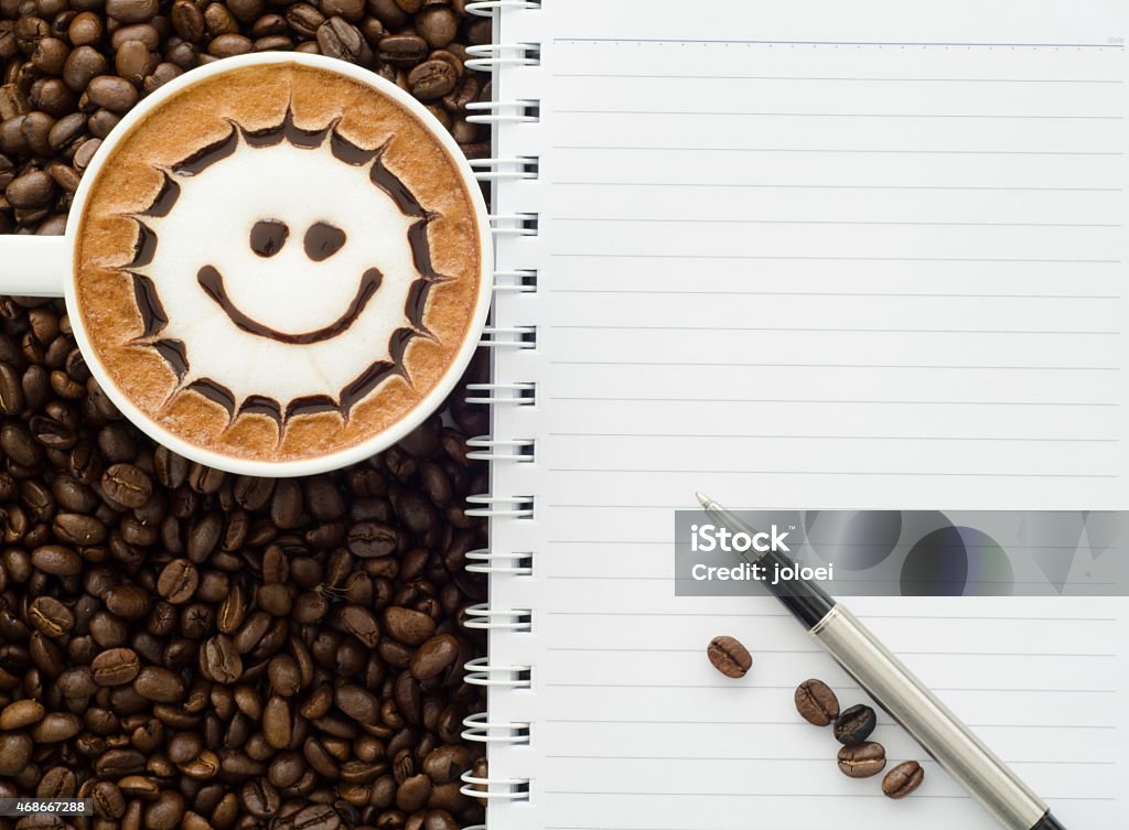 latte art and note book A cup of latte art and note book 2015 Stock Photo