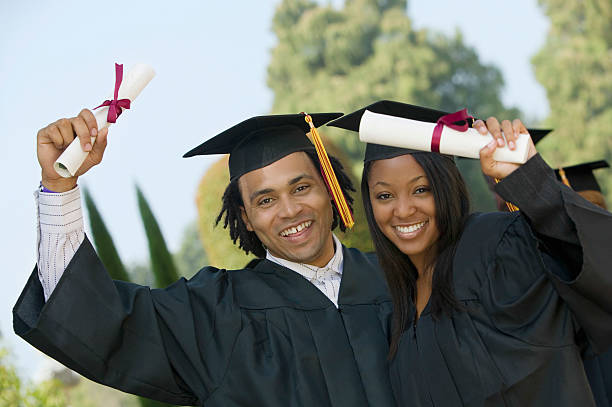 istock Students Holding Diplomas On Graduation Day 468667339
