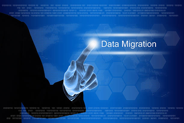 business hand clicking data migration button on touch screen stock photo