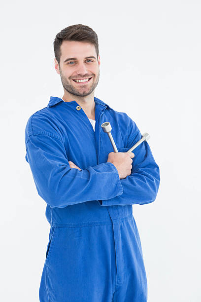 istock Smiling young male mechanic holding spanner 468670940