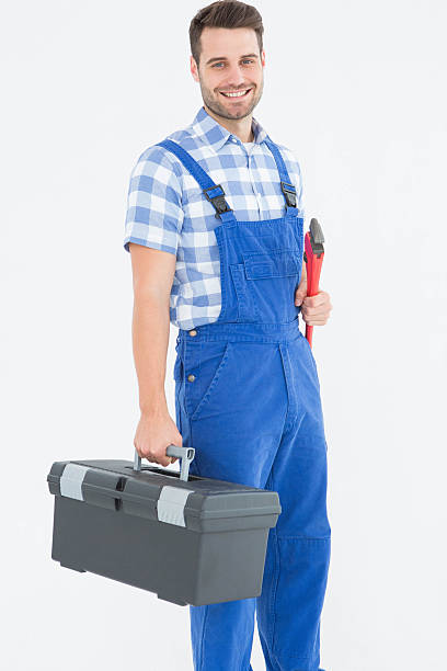 istock Smiling young male repairman carrying toolbox 468671104