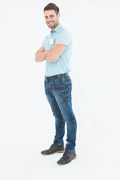 istock Smiling young delivery man standing arms crossed 468671144