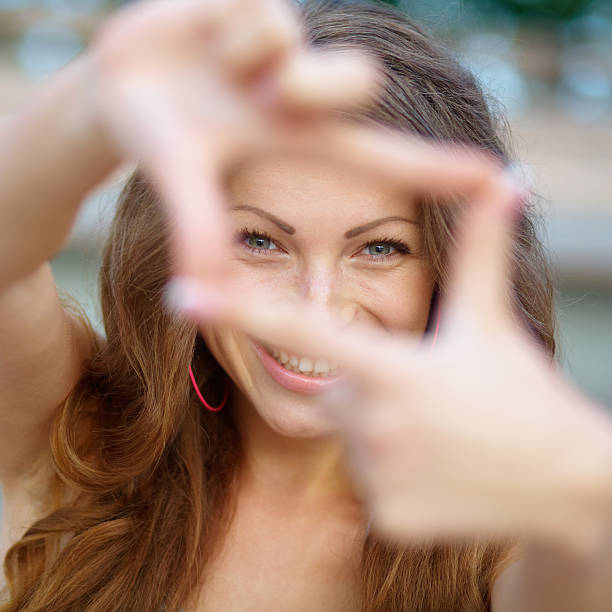 istock Closeup of young beautiful woman making frame with her hands 468671633