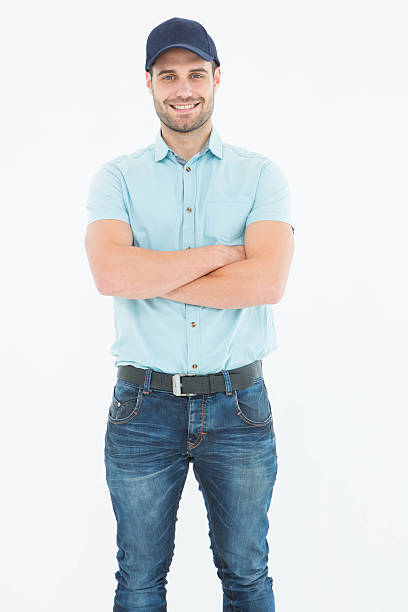 istock Happy delivery man standing arms crossed 468672364