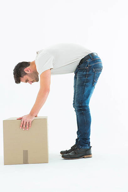 istock Side view of delivery man picking cardboard box 468672622