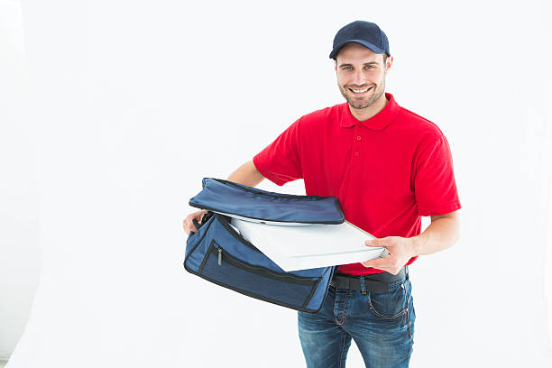 istock Delivery man removing pizza box from bag 468672708