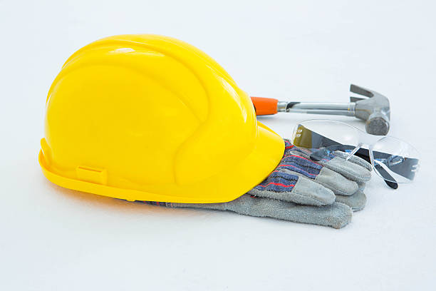 istock Protective gloves with hammer, glasses and yellow hard hat 468673158