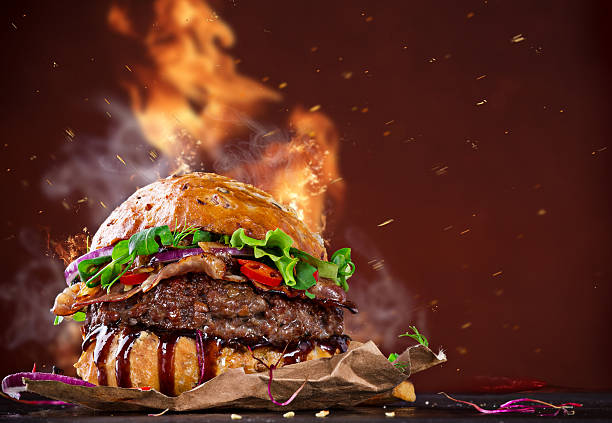 Delicious hamburger with fire flames stock photo