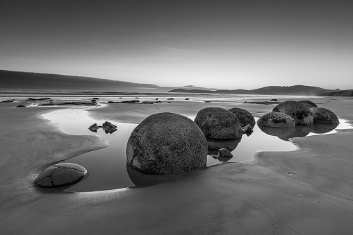 Famous Moeraki Boulders at sunrise, Koekohe beach in black and white ,Otago, South Island, New Zealand