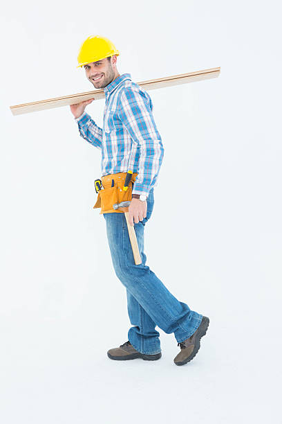 istock Smiling worker carrying wooden planks 468676672