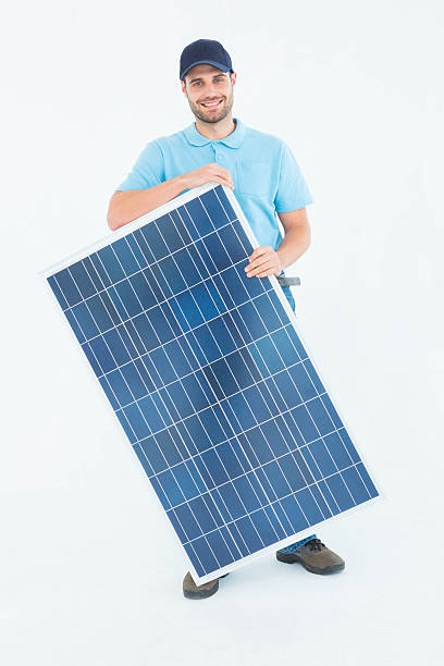 souriant travailleur de la construction en tenant panneau solaire - manual worker full length isolated on white standing photos et images de collection