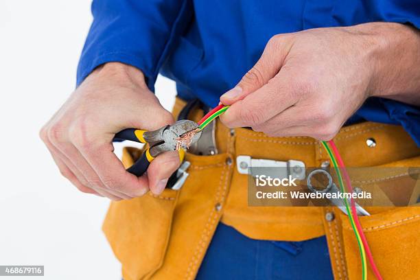 Electrician Cutting Wires Stock Photo - Download Image Now - 20-24 Years, 20-29 Years, 2015