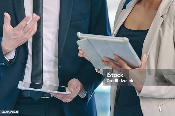 Two Business People Using Digital Tablets Stock Photo - Download Image Now - 2015, Adult, Adults Only