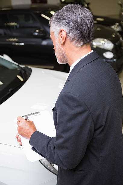 istock Serious businessman writing on clipboard 468679564