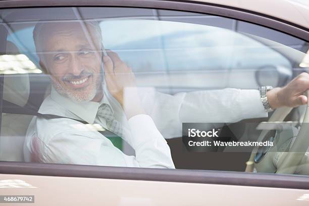 Smiling Businessman On The Phone In His Car Stock Photo - Download Image Now - 2015, 50-54 Years, 50-59 Years