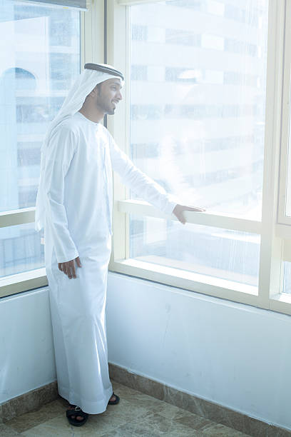 istock Arab businessman looking through business building window 468679928