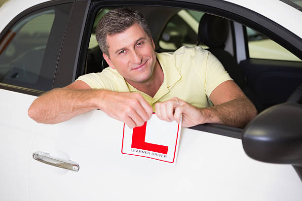 istock Cheerful male driver tearing up his L sign 468680932