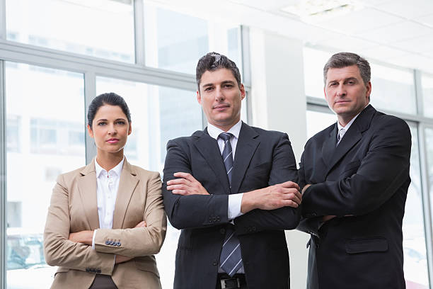 istock Serious business team standing with arms crossed 468681164