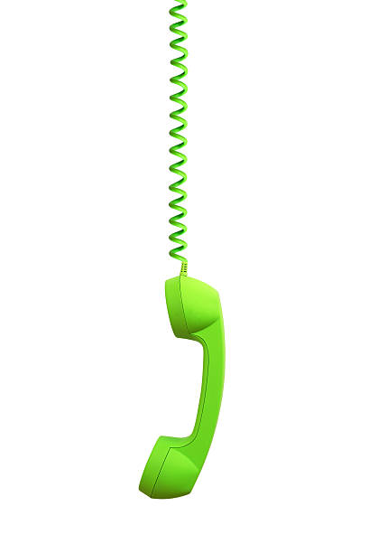 Green phone receiver hanging, isolated on white background stock photo