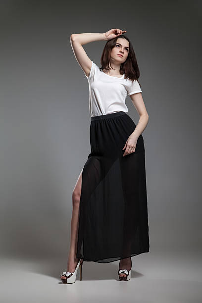istock Beautiful model in white top and black skirt posing on 468685034