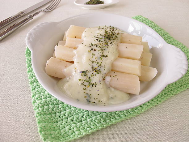 Black salsify roots with bechamel sauce stock photo