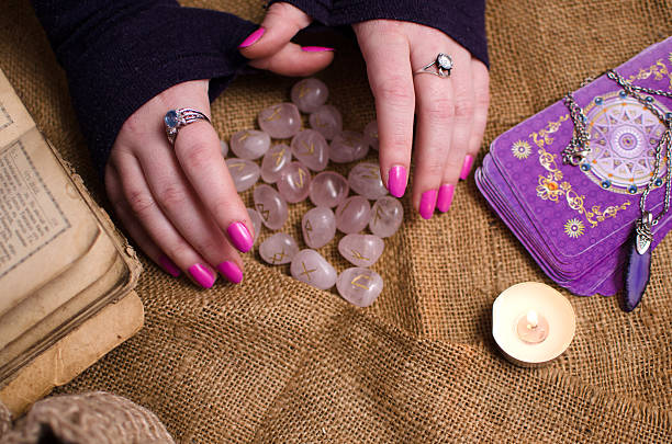 istock female hand holding a magic rune stone 468685976